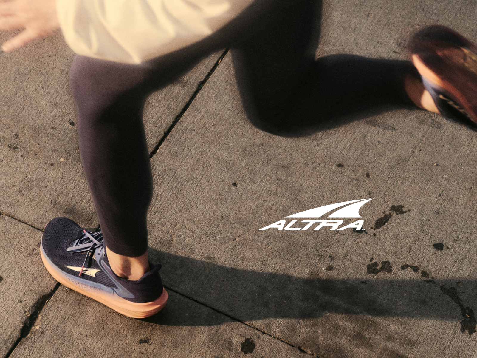 Woman running in Altra Torin