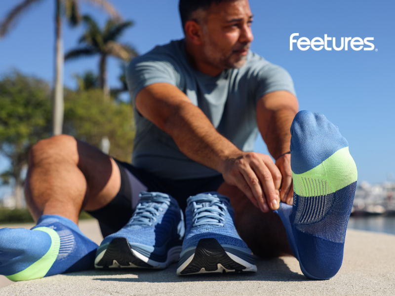 Man putting on Feetures socks