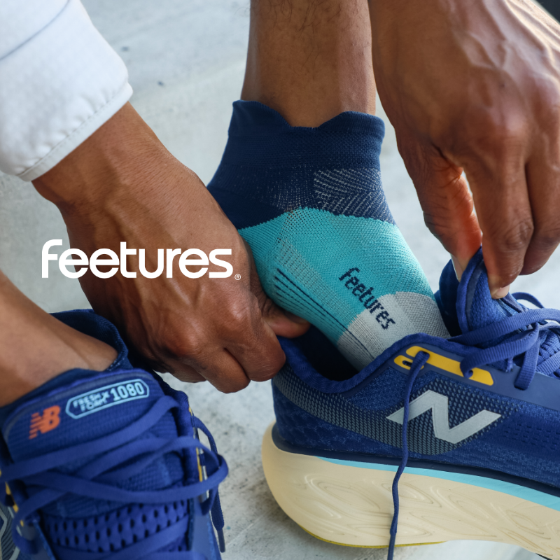 Man putting on Feetures socks