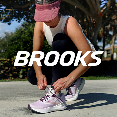 Woman lacing up a pair of Brooks Adrenaline GTS 24 running shoes