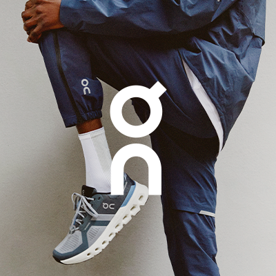 Man stretching wearing ON Cloudrunner running shoes