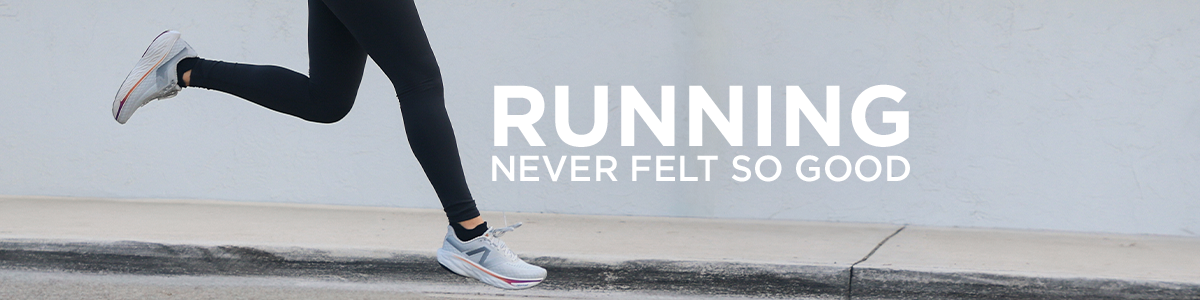 Woman running on sidewalk wearing New Balance 1080 v14 running shoes
