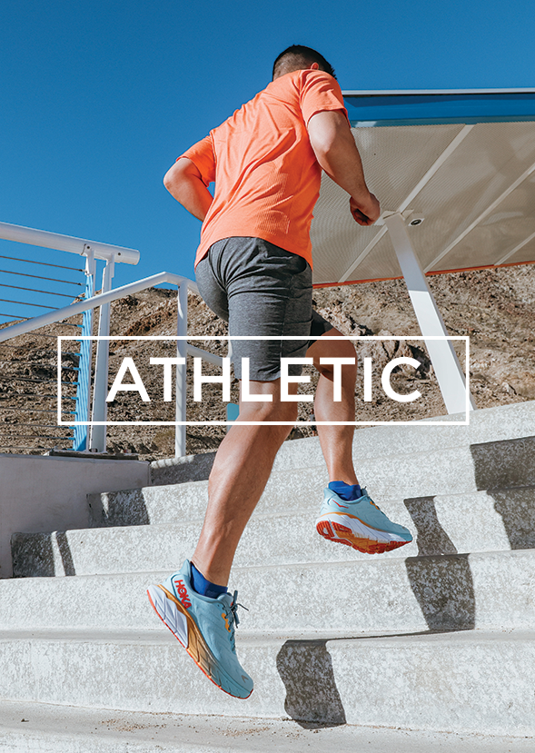 man running up stairs in athletic shoes