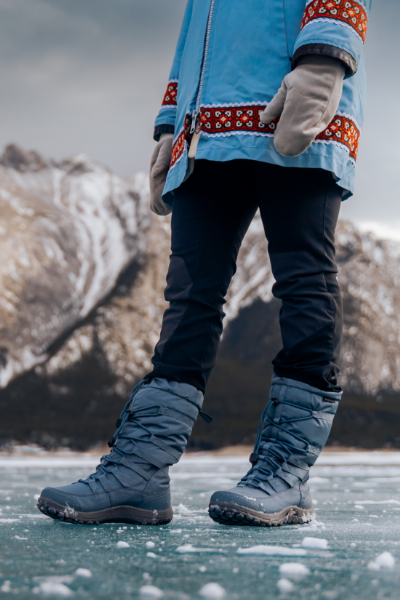 Woman standing on iced over lake