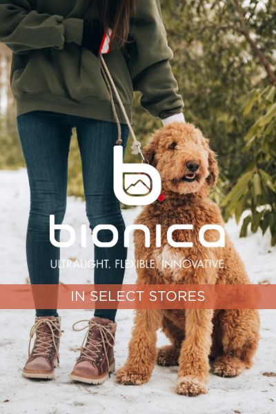 Woman standing in snow with dog 
