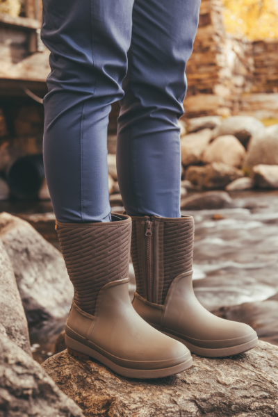 Woman standing on rock by the river