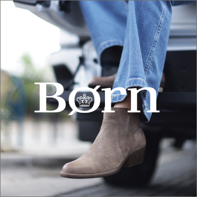 Woman sitting on back of truck in Born shoes 
