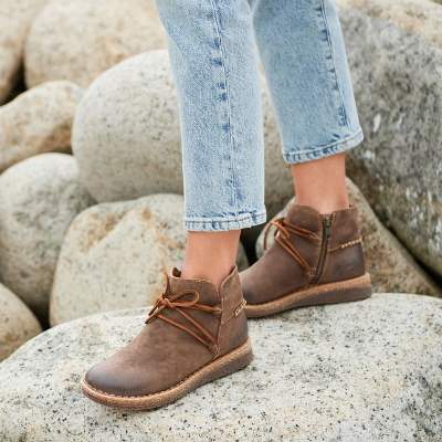 Woman posing on rock in Born shoes 