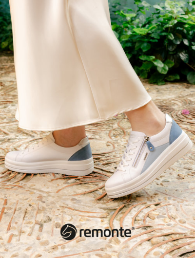 Woman standing on pathway wearing Remonte sneakers