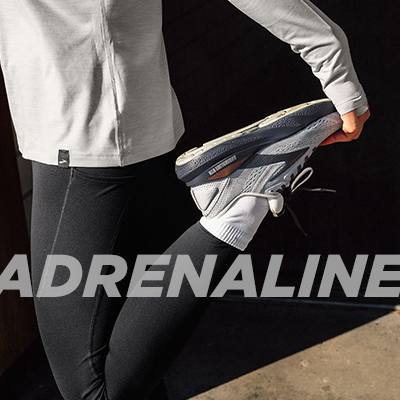 Woman stretching wearing Brooks Adrenaline GTS 24 running shoes