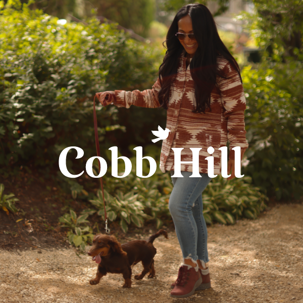 Woman walking dog in park