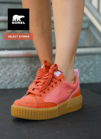 Woman wearing Sorel sneakers on stairs