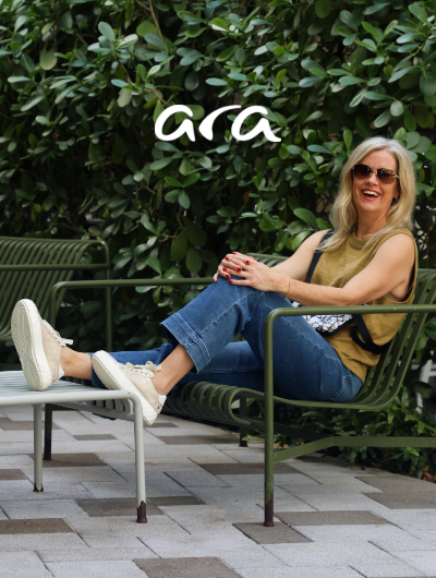 Woman sitting on bench wearing Ara sneakers