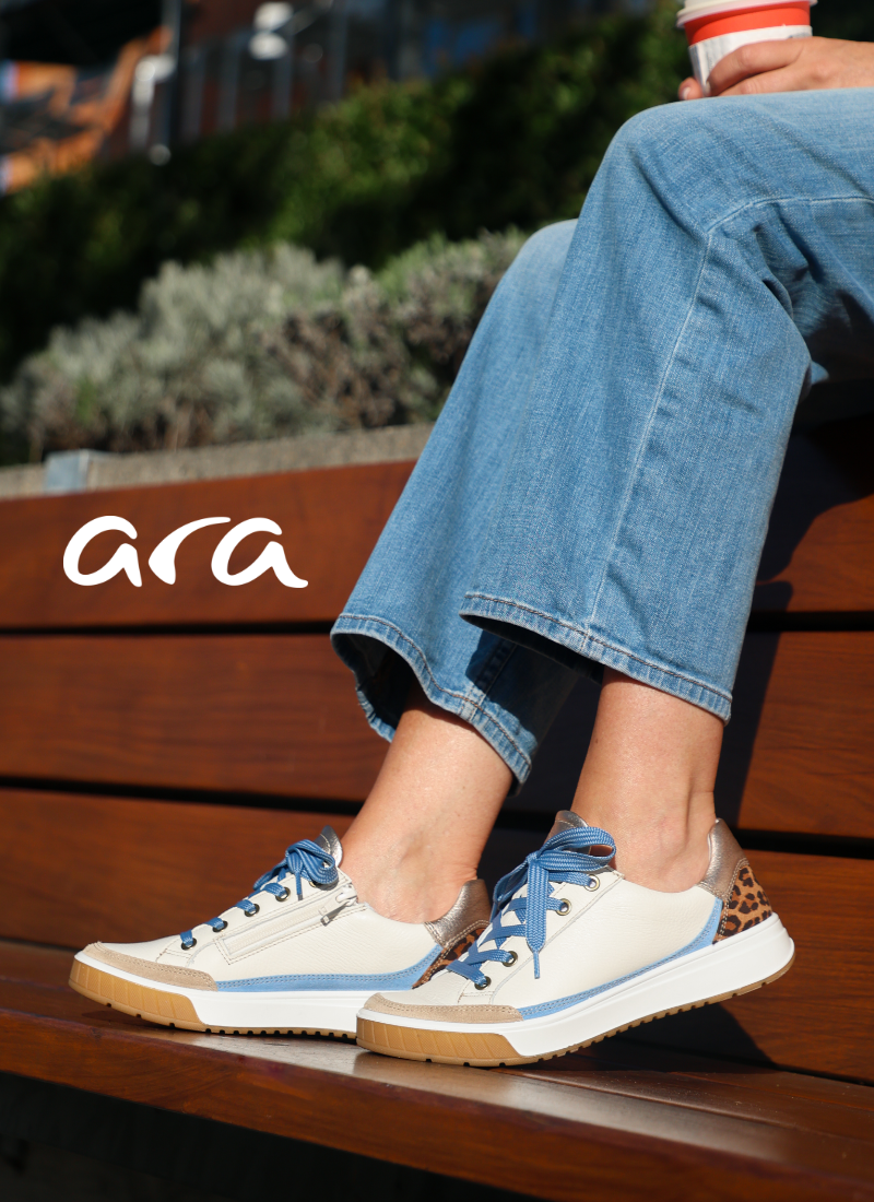 Woman resting feet on bench wearing Ara sneakers