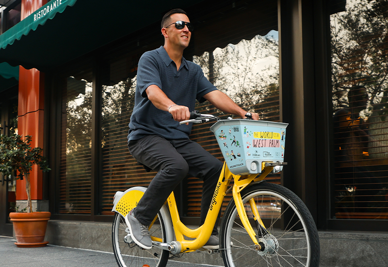 Man riding a bike wearing Clarks Mapstone Lace sneakers