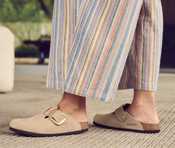 Birkenstock Boston Big Buckle Woman wearing a striped jumpsuit and Birkenstock Boston Big Buckle clogs