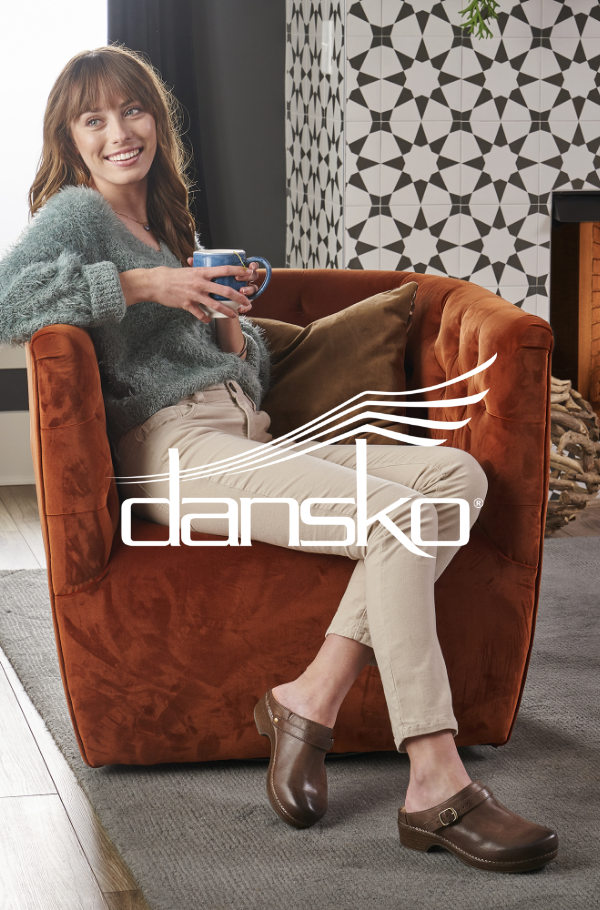 Woman lounging in chair with coffee in hand 