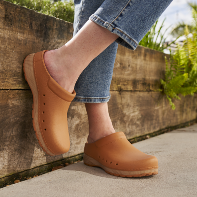 Woman crossing feet in Dansko shoes 
