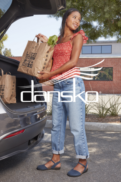 Woman unloading groceries from back of car