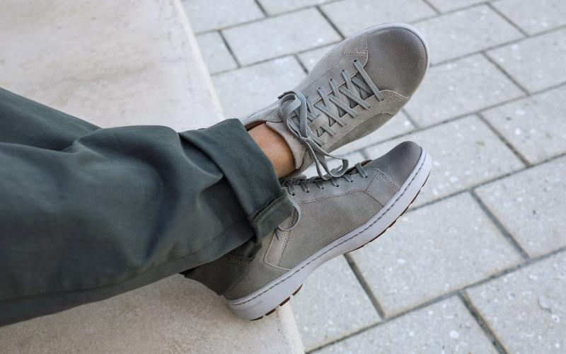 Man sitting on steps wearing Dansko Trevor sneakers