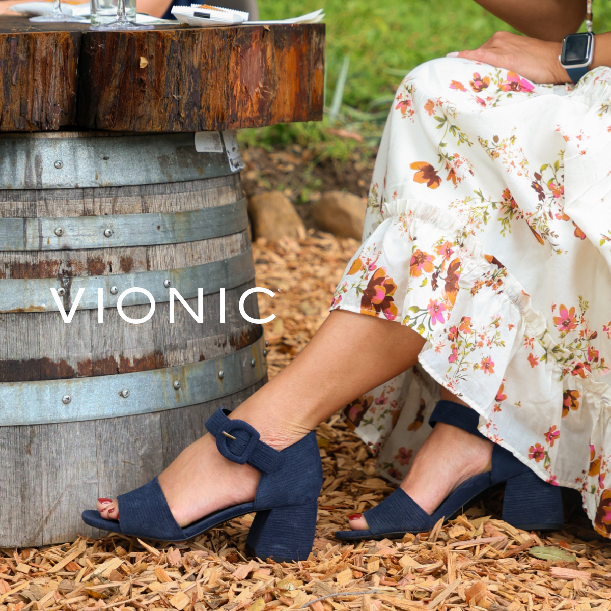 Woman sitting in chair wearing Vionic sandals