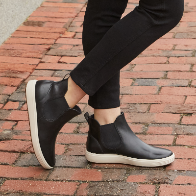 Woman crossing legs on sidewalk