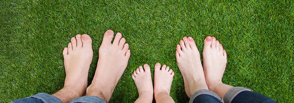 Feet standing on grass