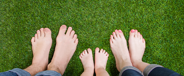 Feet standing on grass