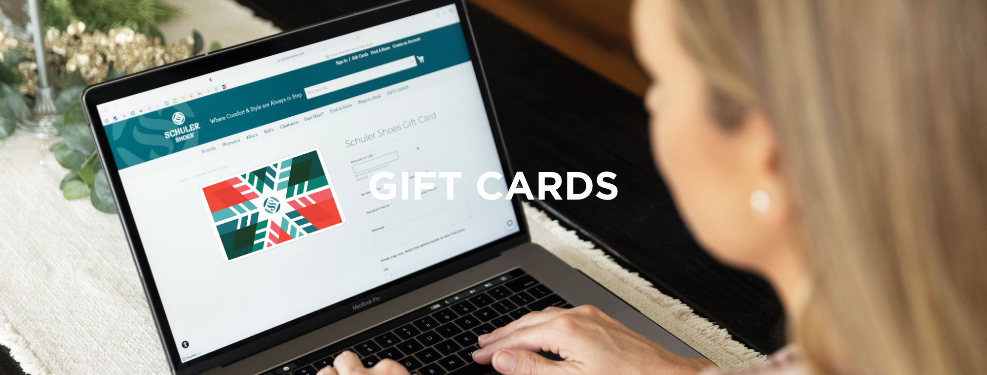 Woman shopping for gift card on laptop