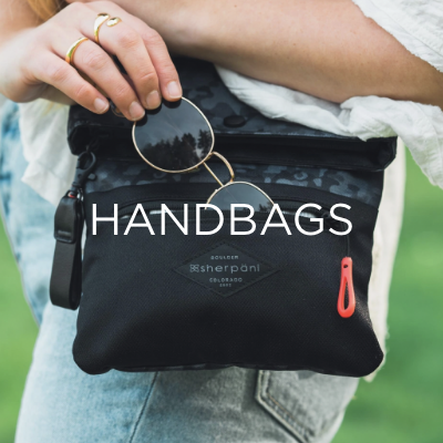 Woman putting sunglasses into handbag