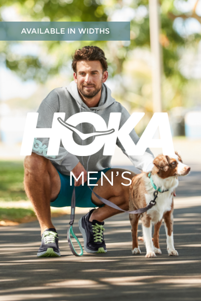 Man holding dog on pathway