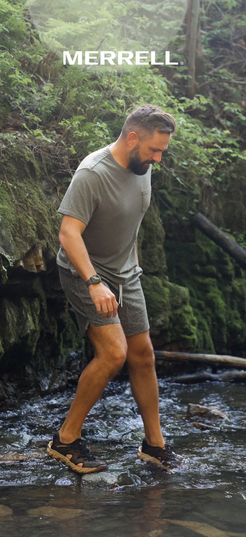 Man wearing Merrell sandals in river