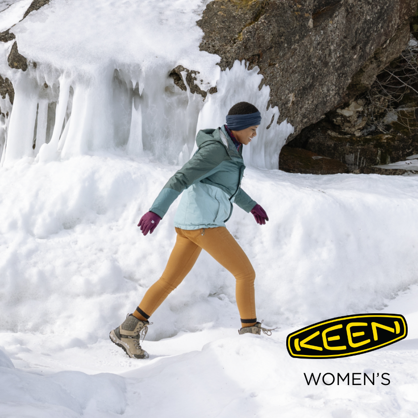 Woman walking on snow path