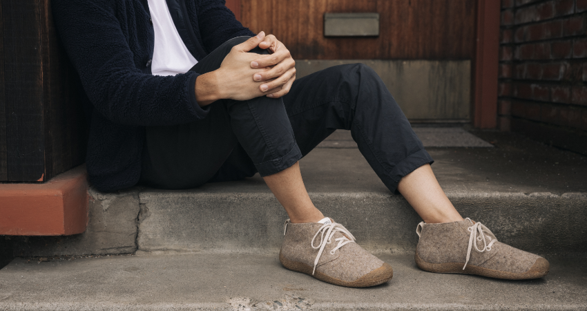 Man sitting on step in Keen shoes 