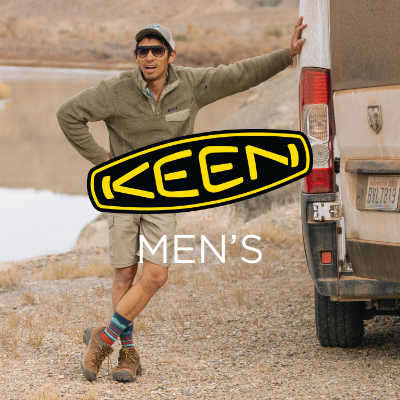 Man standing by side of van with hand leaning against it