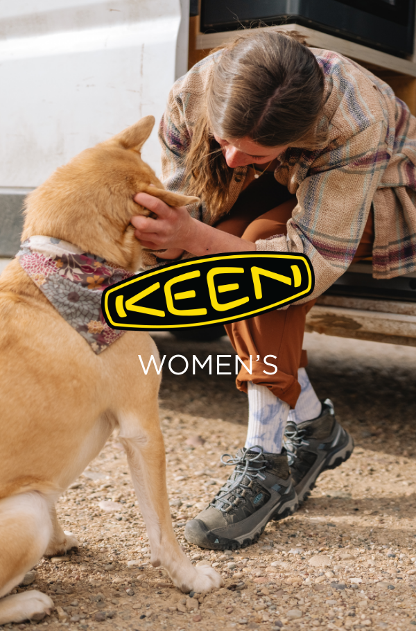 Woman petting dog in Keen shoes 