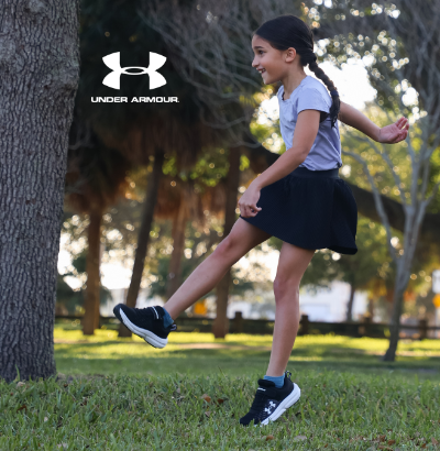 Kid kicking soccer ball in Under Armour
