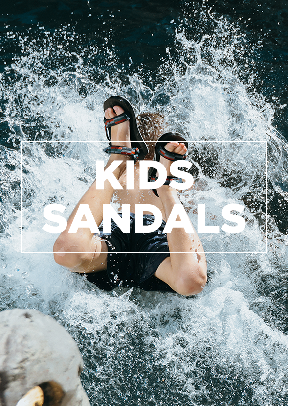 boy wearing sandals jumping into water