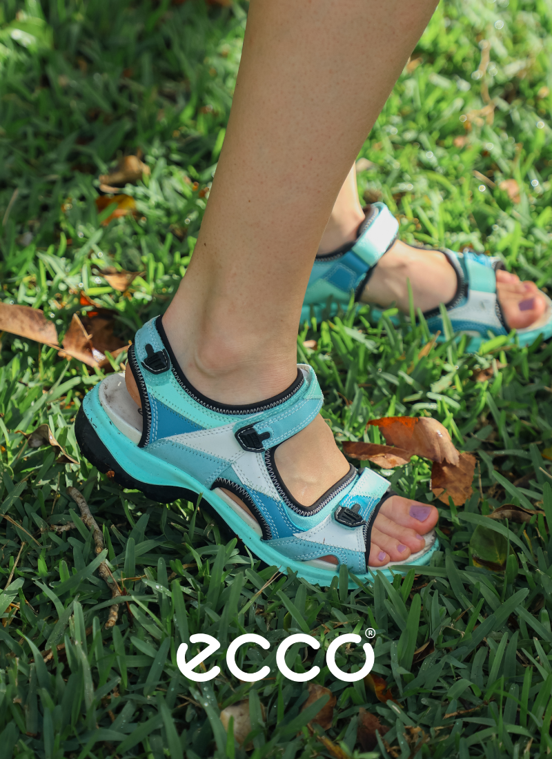 Woman standing in grass in Ecco sandals