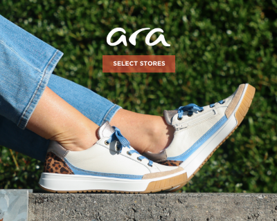Woman sitting on bench wearing Ara sneakers