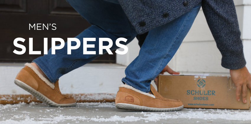 Man grabbing Schuler Shoes box off front porch
