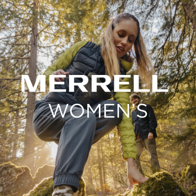 Woman climbing down rock