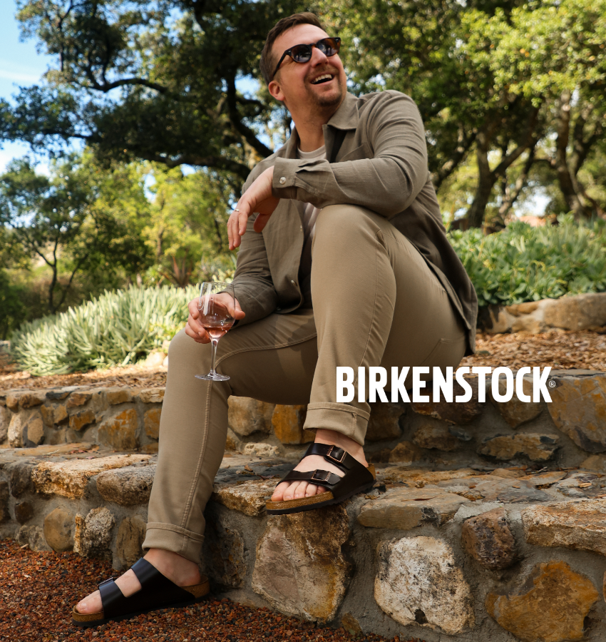 Man sitting on outdoor stairs in Birkenstock Arizona's