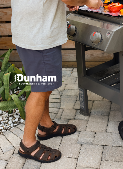 Man grilling wearing Dunham sandals