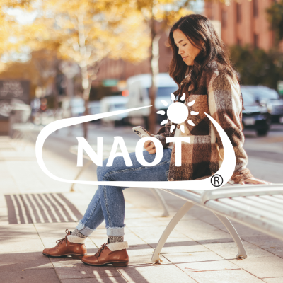 Woman sitting on bench in city