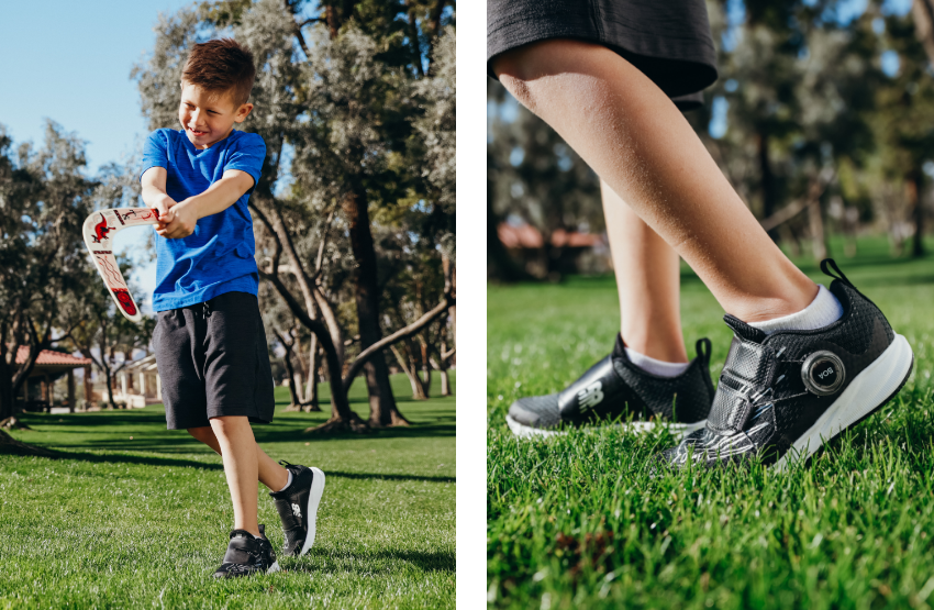 Boy playing with boomerang in grass