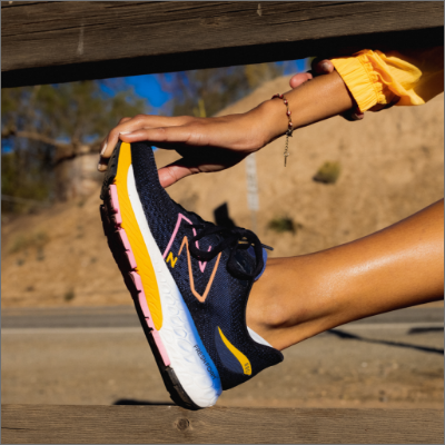 Woman stretching in New Balance shoes 