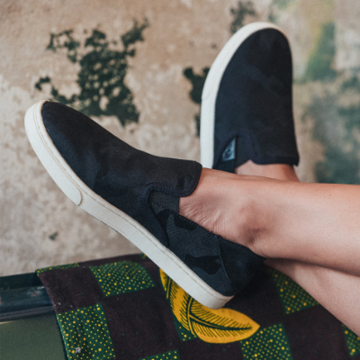 Woman crossing her feet in OluKai shoes
