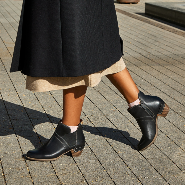 Woman posing feet on sidewalk