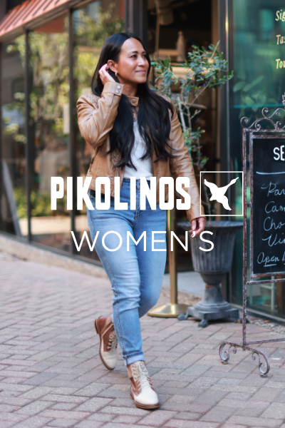 Woman walking past store fronts 